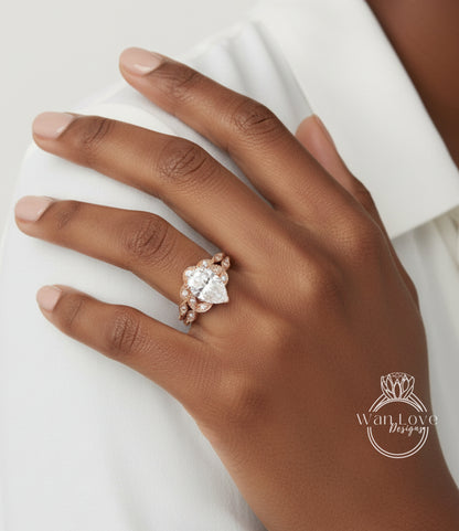 A close-up of a hand wearing a diamond engagement ring, with the ring's centerpiece being a large, clear gemstone surrounded by smaller stones.