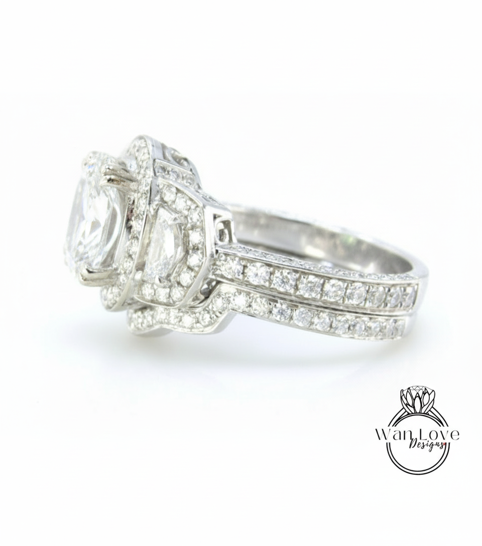 A close-up view of a diamond engagement ring with a large central diamond surrounded by smaller diamonds on either side.