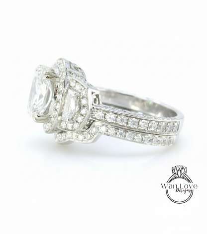 A close-up view of a diamond engagement ring with a large central diamond surrounded by smaller diamonds on either side.