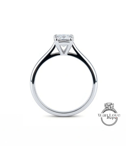A silver engagement ring with a large central diamond.