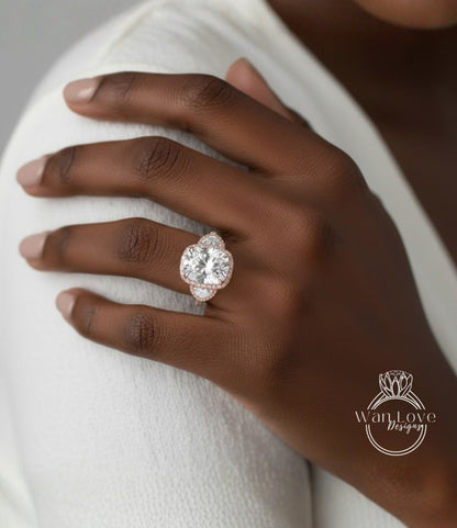 A close-up of a person's hand wearing a large, ornate diamond ring.