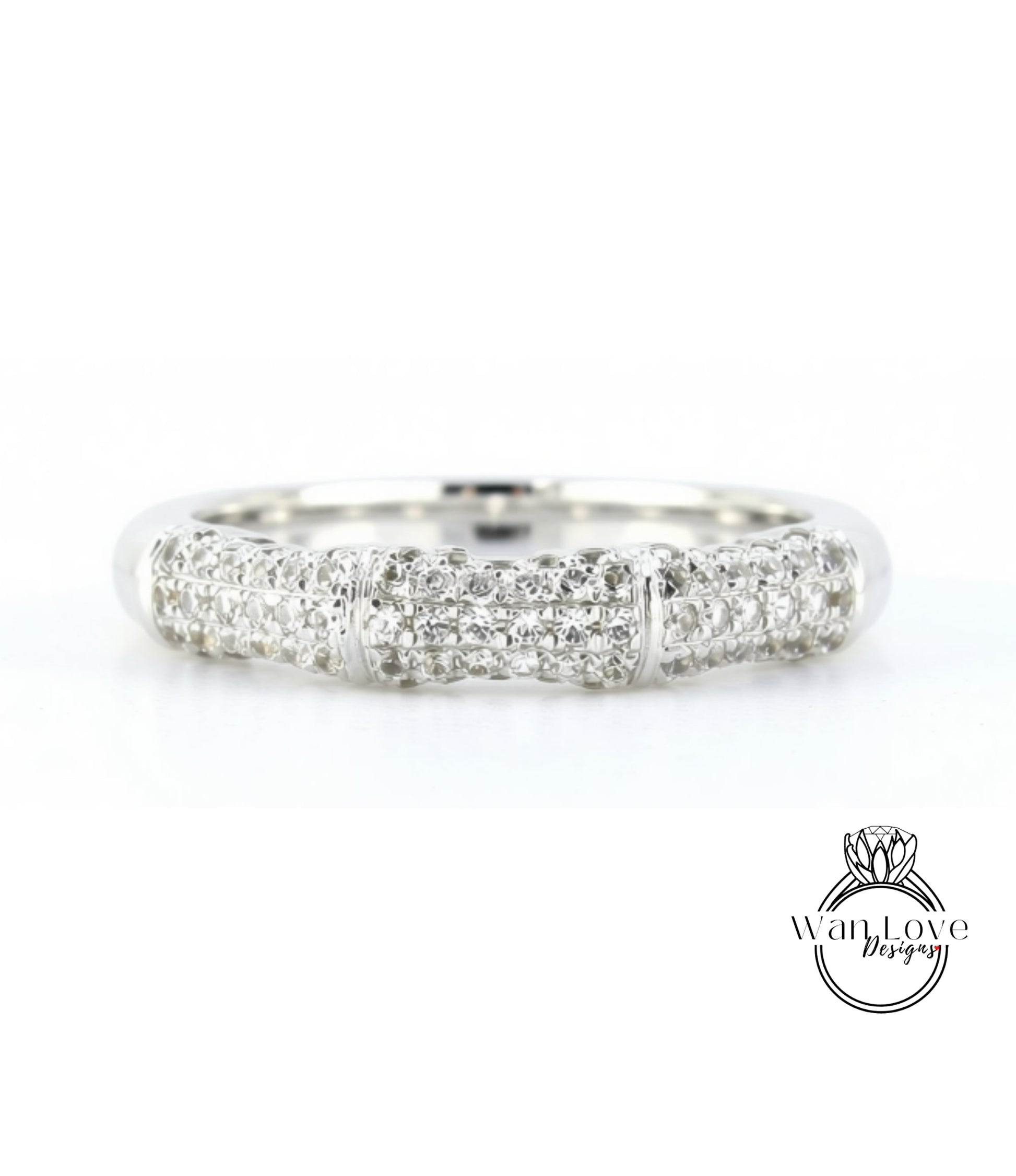 A silver ring with a row of small diamonds set in it.