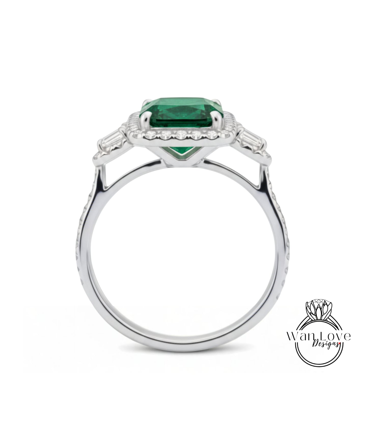 A silver ring with a large, vibrant green gemstone set in the center, surrounded by smaller diamonds.