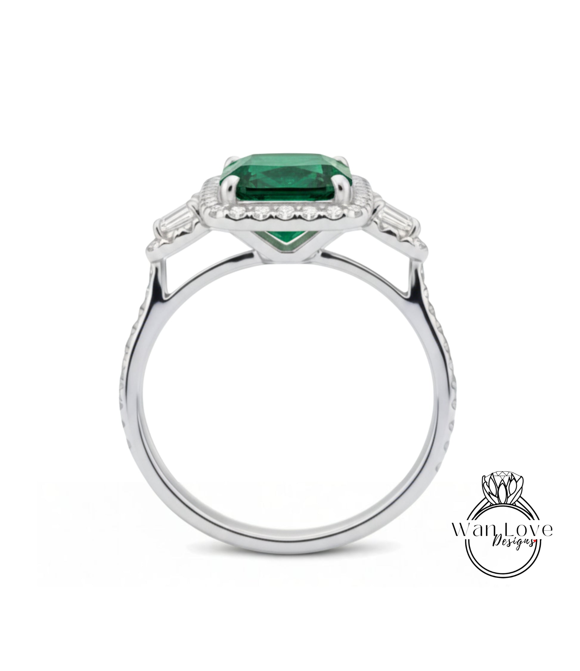 A silver ring with a large, vibrant green gemstone set in the center, surrounded by smaller diamonds.