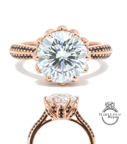 a beautiful rose gold ring with a large, round diamond set in the center. The ring has a scalloped edge and a black band around the base, creating an elegant and eye-catching design.
