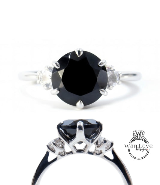 a silver ring with a large black diamond as the centerpiece.