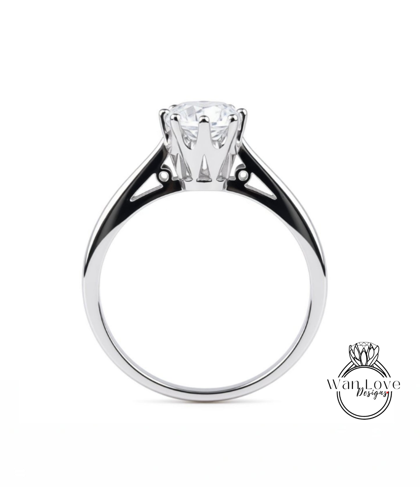 A silver engagement ring with a large central diamond and a smaller diamond on either side.
