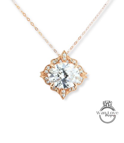 A necklace with a large, clear gemstone set in an ornate, floral-designed metal frame.