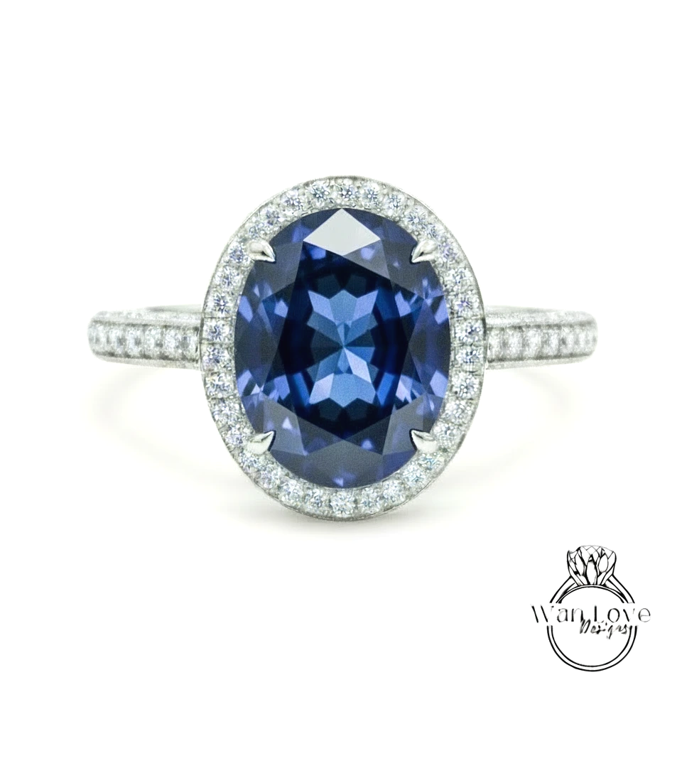 A stunning blue gemstone ring with a halo of sparkling diamonds around the center stone.