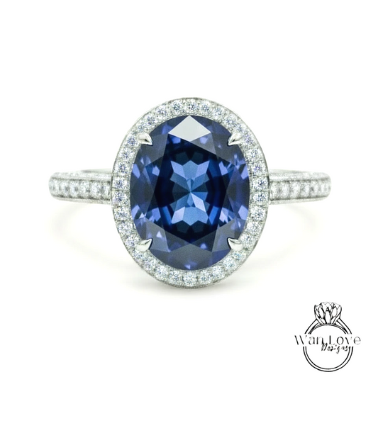 A stunning blue gemstone ring with a halo of sparkling diamonds around the center stone.