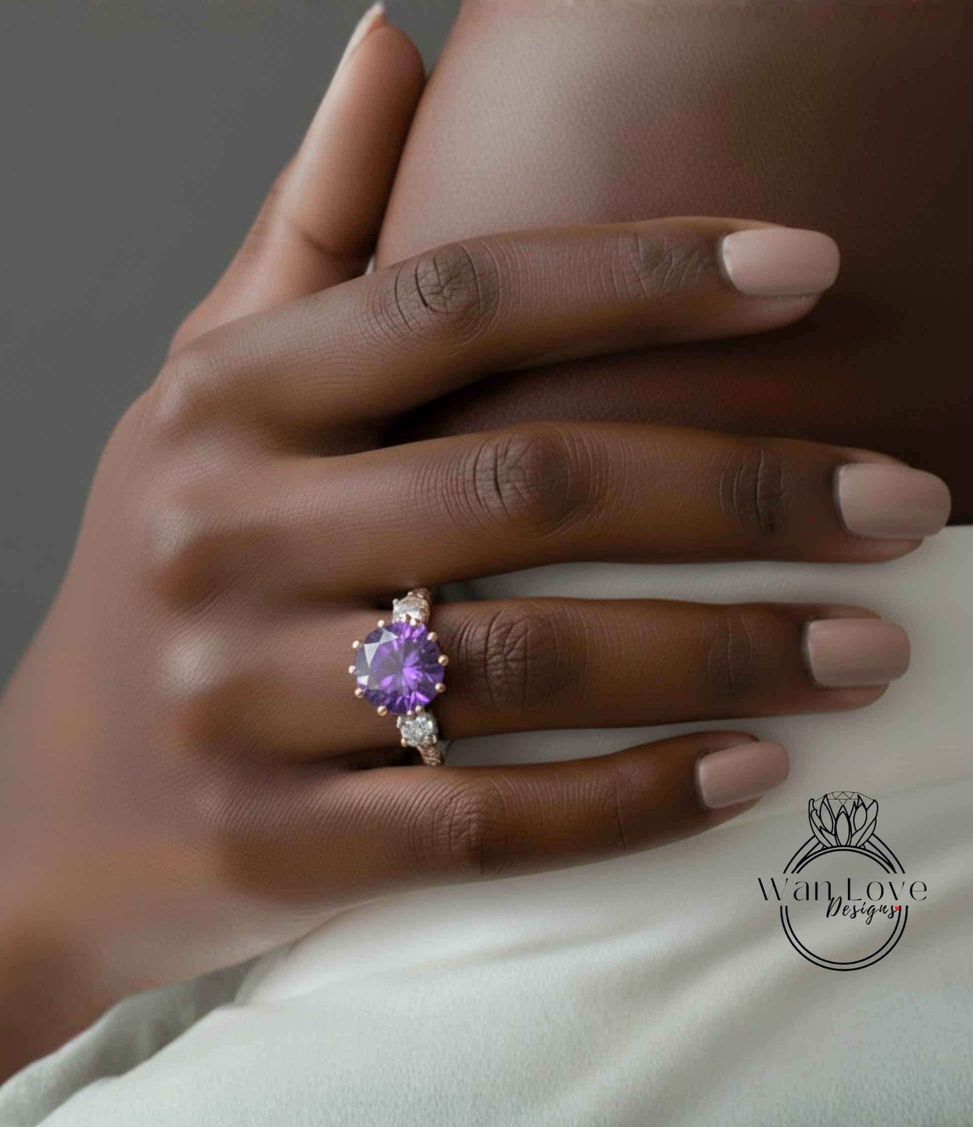 A close-up of a hand wearing a ring with a large purple gemstone.
