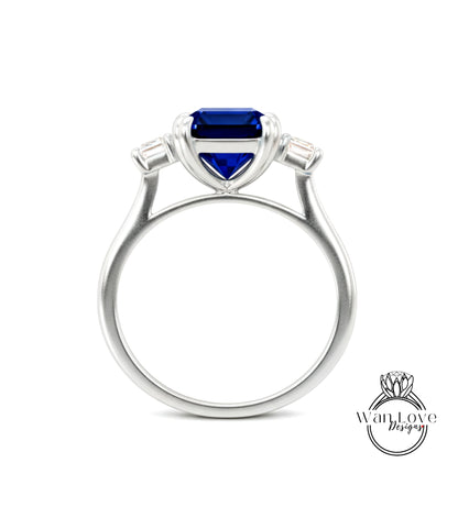 A silver ring with a large blue gemstone, possibly a sapphire, set in the center.