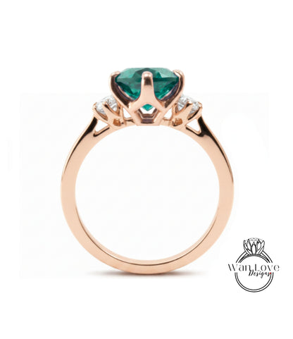 A gold ring with a large, green gemstone set in the center.