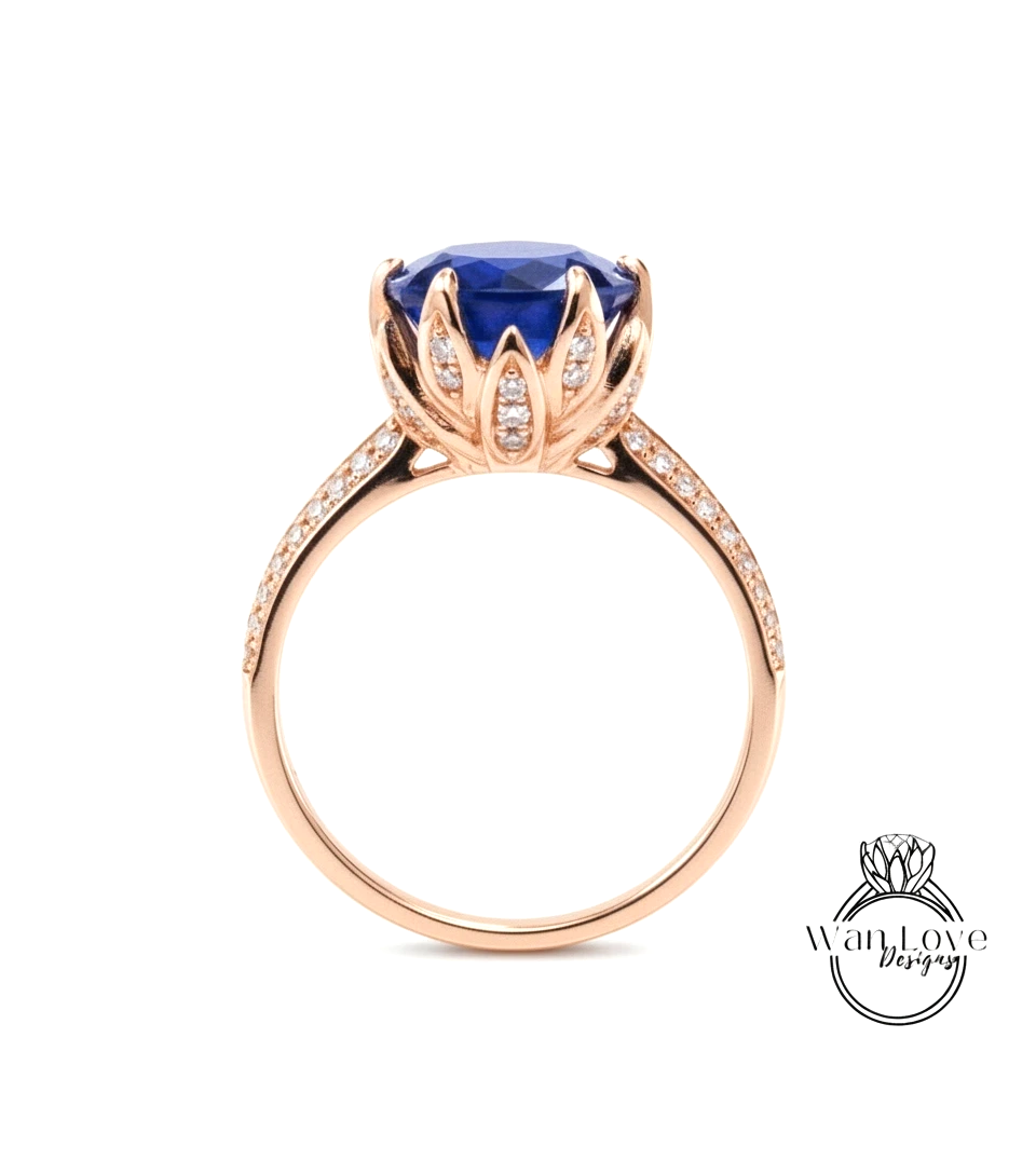 A gold ring with a large blue gemstone, possibly a sapphire, set in a decorative flower-like design.