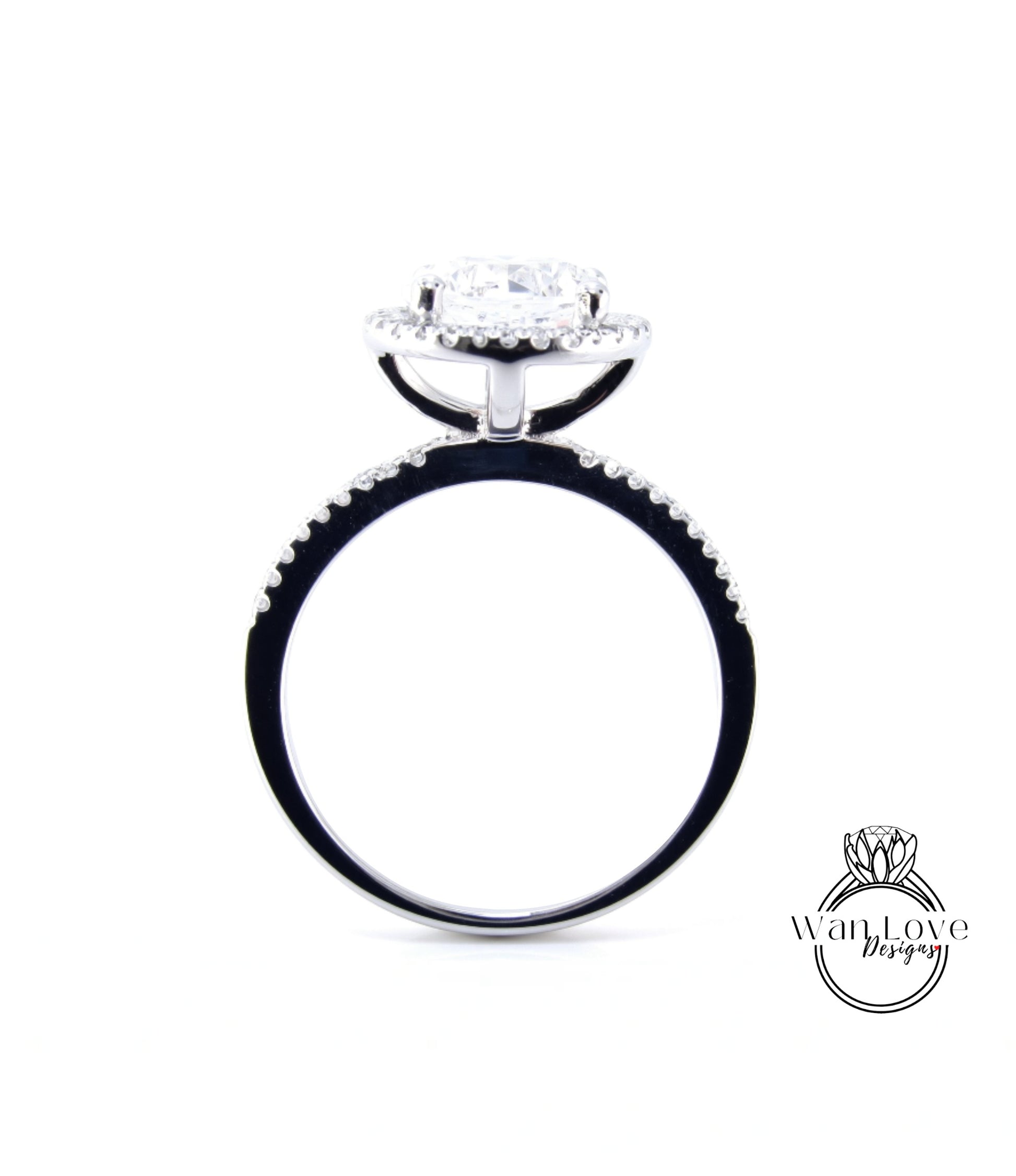 A silver engagement ring with a large central diamond surrounded by smaller diamonds, set in a halo of smaller diamonds.