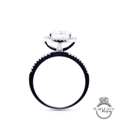 A silver engagement ring with a large central diamond surrounded by smaller diamonds, set in a halo of smaller diamonds.