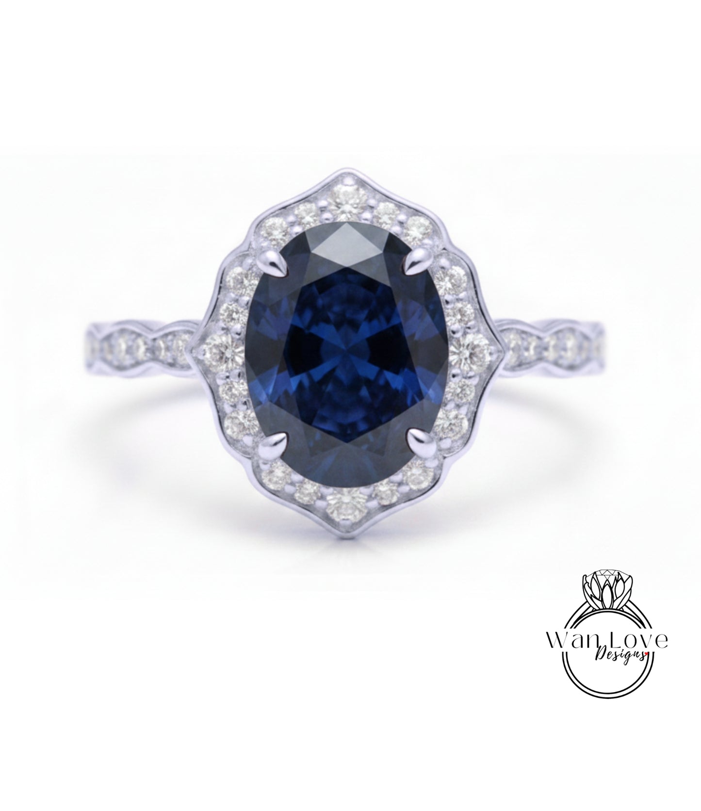 A close-up of a silver ring with a large oval-shaped blue gemstone at the center, surrounded by smaller diamonds.