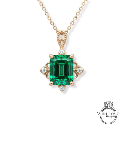 A gold necklace with a large, green gemstone pendant.