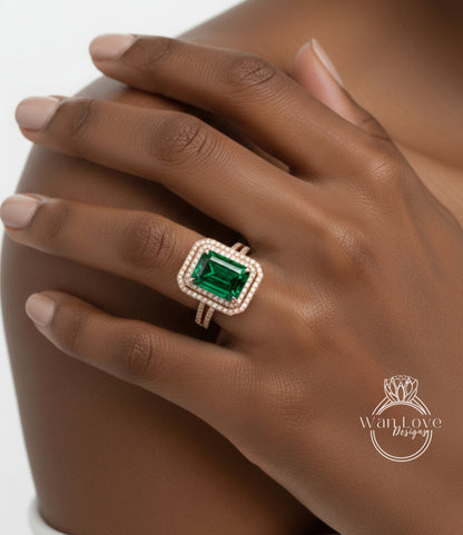 A close-up of a person's hand wearing a large, ornate ring with a green gemstone.