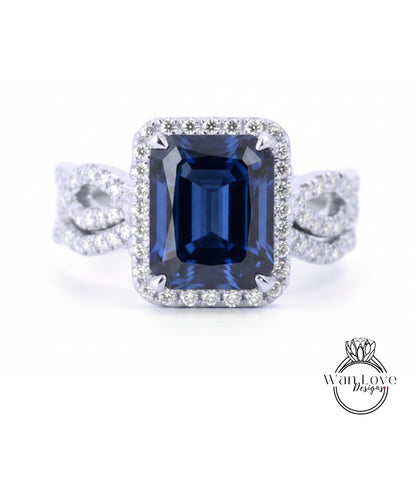 A stunning diamond engagement ring with a large blue gemstone set in a halo of smaller diamonds.