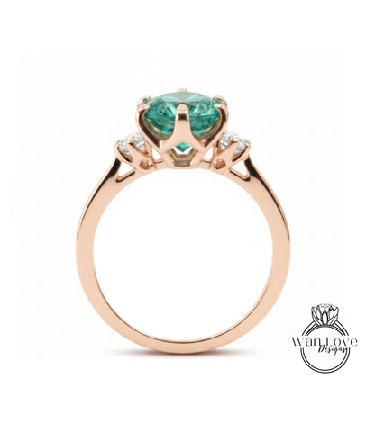 A gold ring with a large, green gemstone set in the center.
