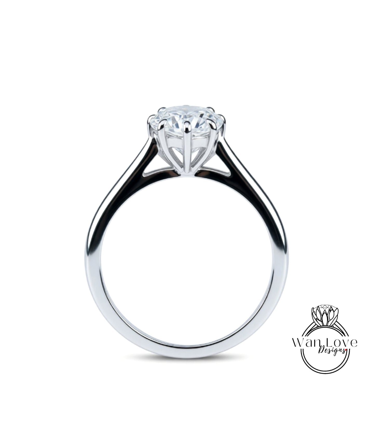 A silver engagement ring with a large central diamond and a smaller diamond on either side.