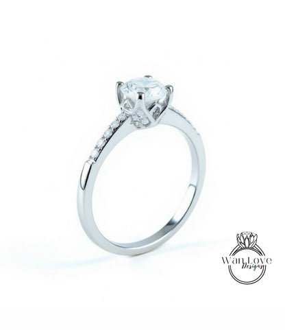 A silver engagement ring with a large central diamond and a halo of smaller diamonds around the edge.