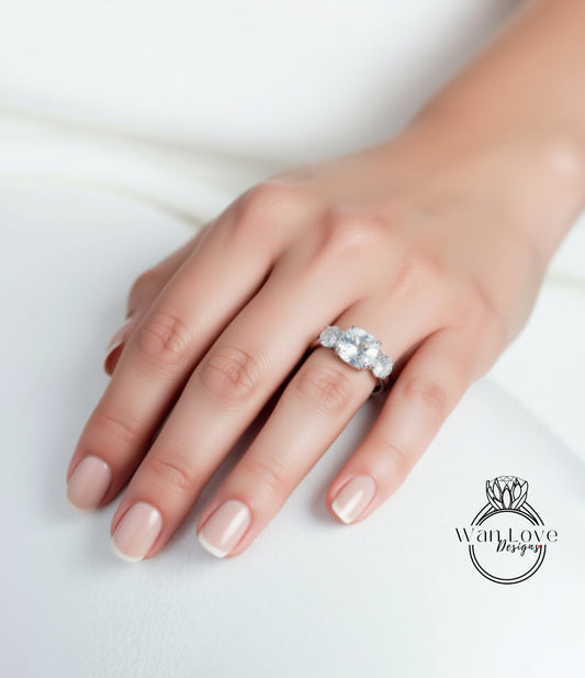 A close-up of a hand wearing a diamond ring on the ring finger.