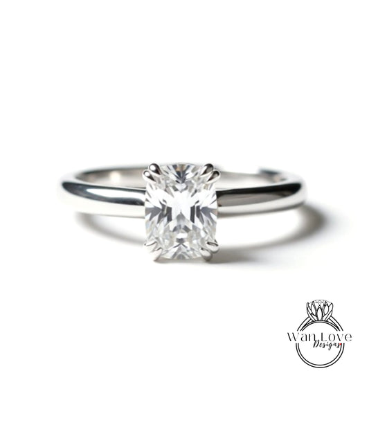 A close-up view of a diamond engagement ring with a large, clear gemstone set in a silver band.