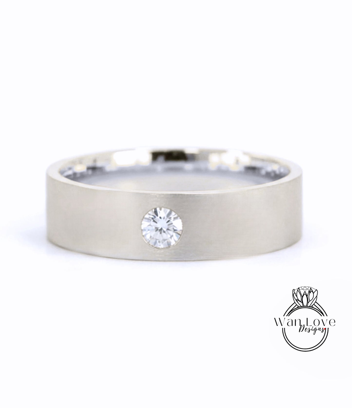 A silver-colored ring with a large diamond set in the center.