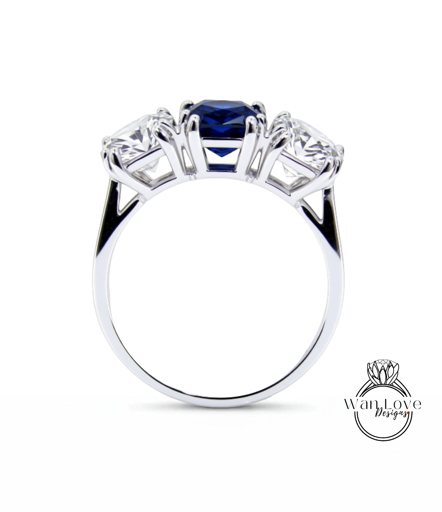 A silver ring with three gemstones, including a blue gemstone, set in a three-prong design.