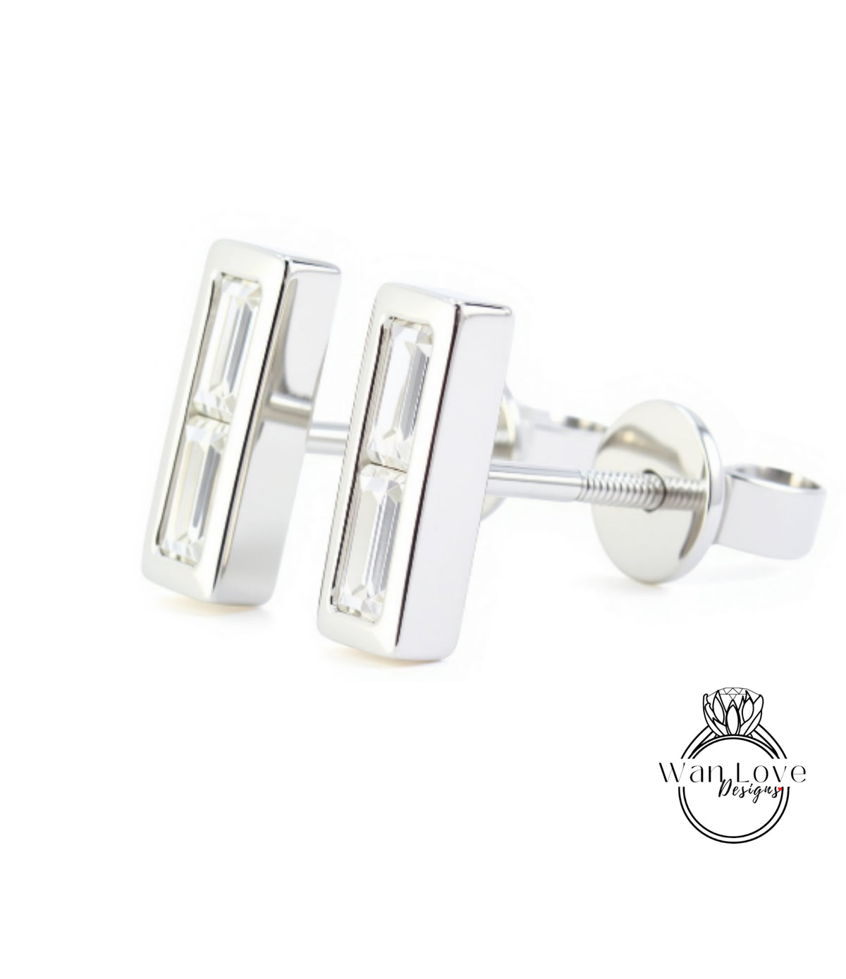 A pair of silver earrings with rectangular cut gemstones.
