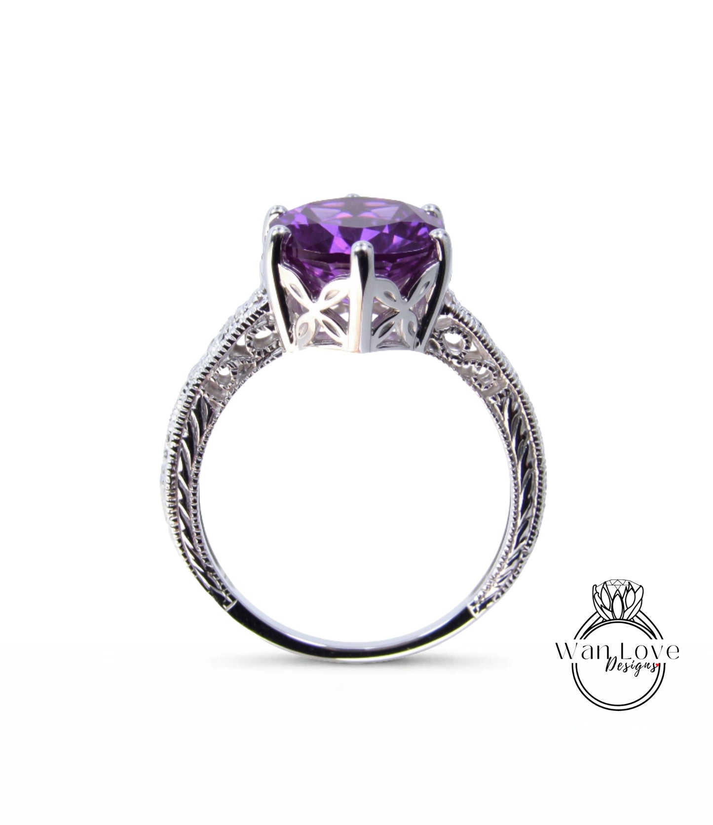 A silver ring with a large purple gemstone, possibly an amethyst, set in an intricate, decorative metal band.