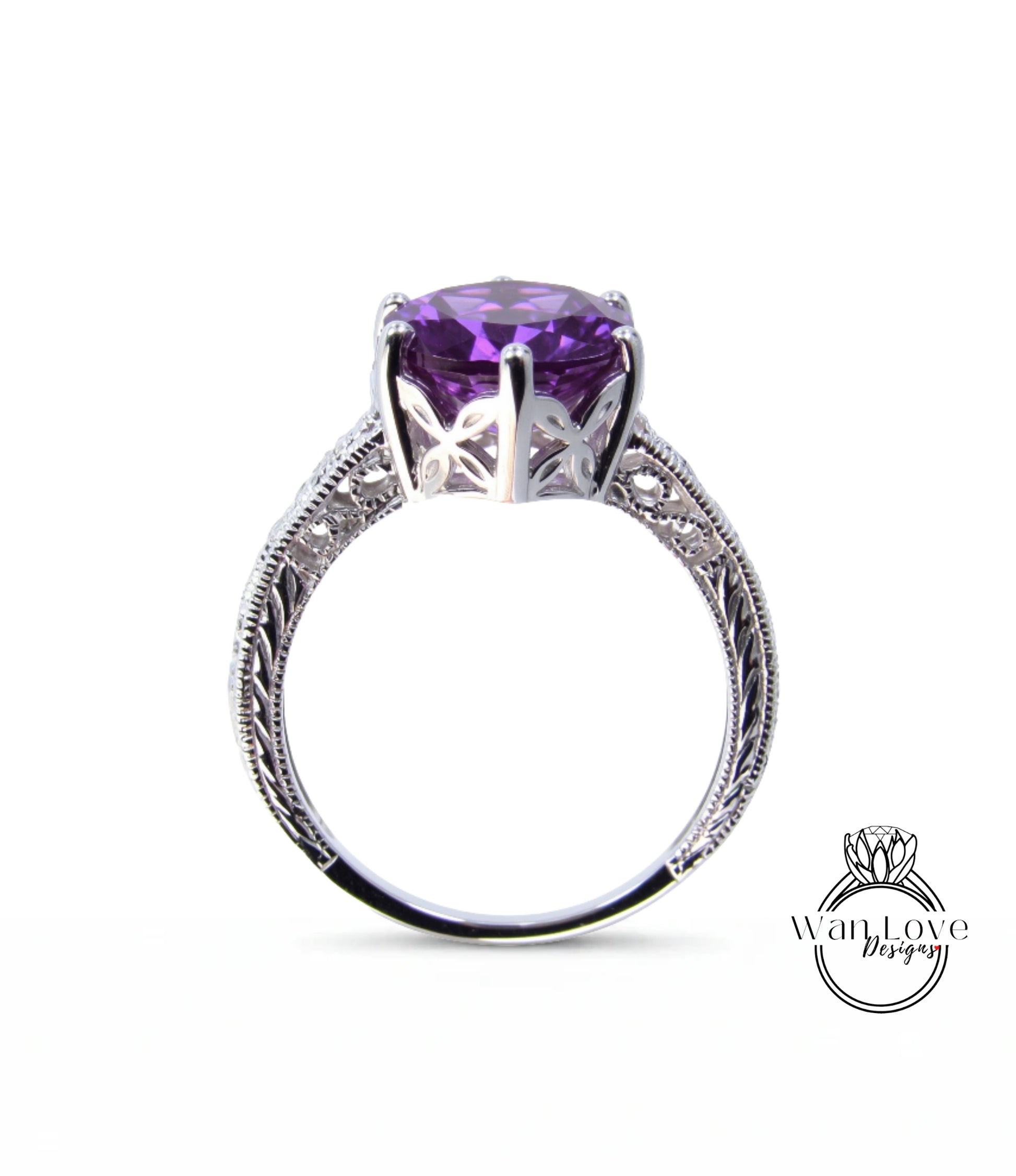 A silver ring with a large purple gemstone, possibly an amethyst, set in an intricate, decorative metal band.