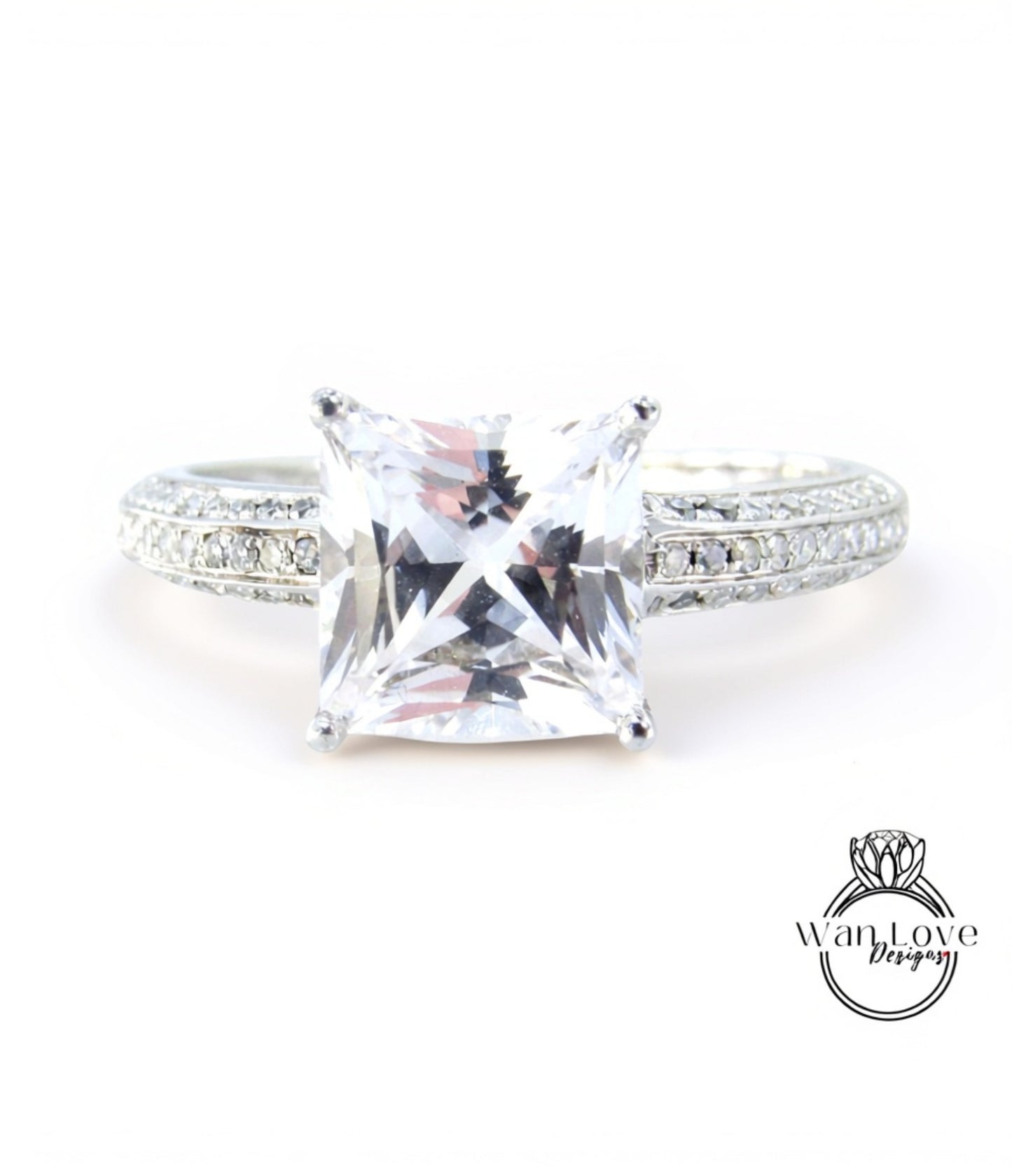 A close-up view of a diamond engagement ring with a large, clear gemstone set in a silver band.