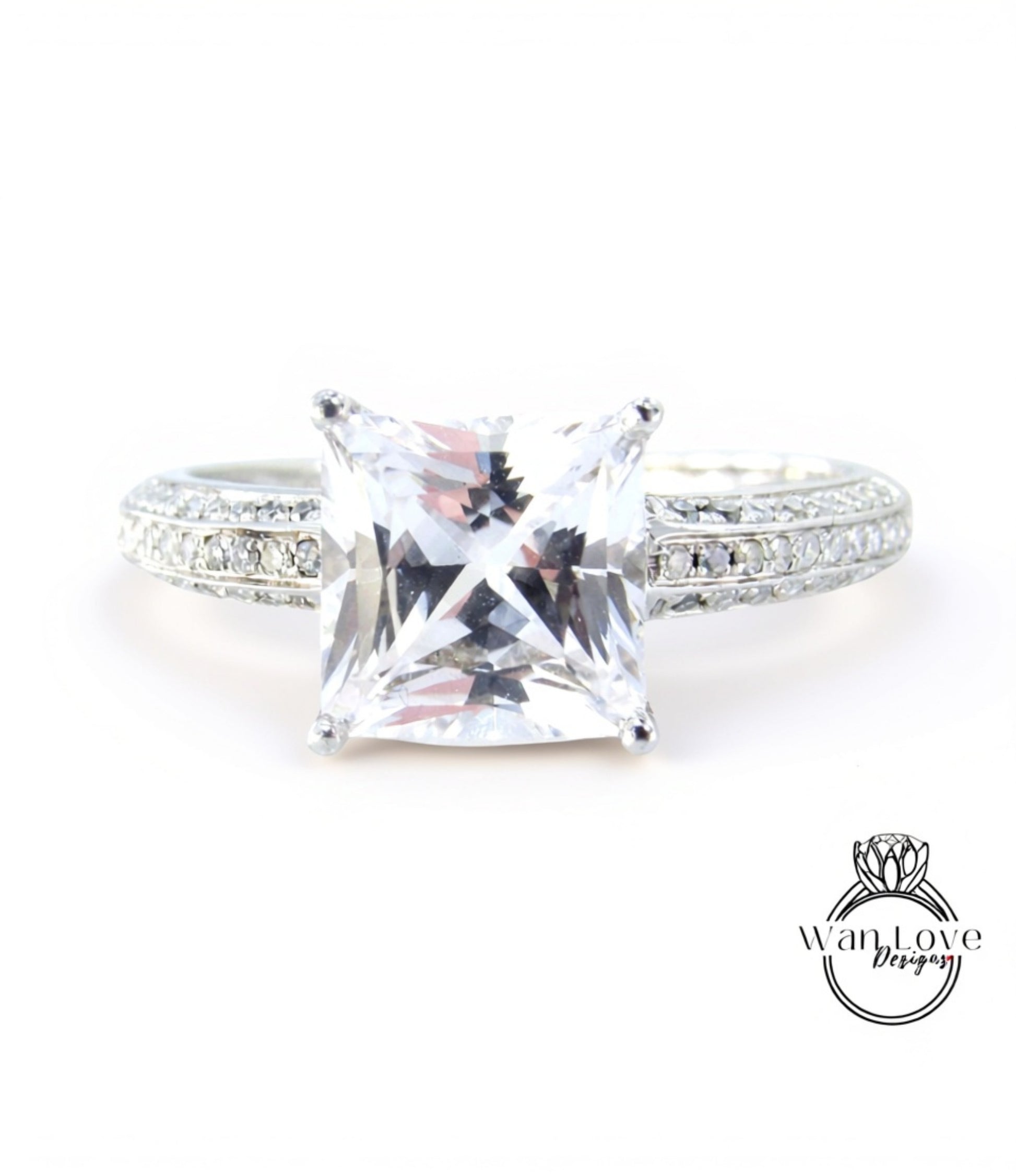 A close-up view of a diamond engagement ring with a large, clear gemstone set in a silver band.