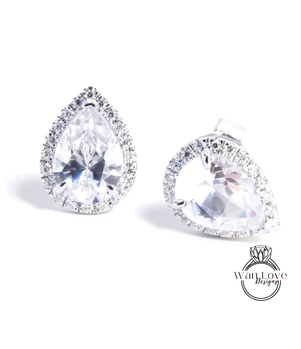 A pair of elegant earrings with large, clear gemstones set in a halo of smaller diamonds.