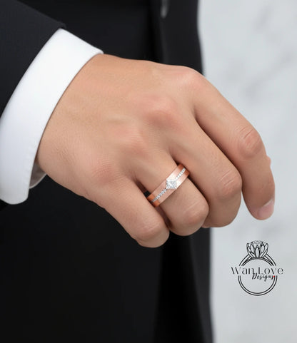A close-up of a person's hand wearing a gold wedding band with a diamond.