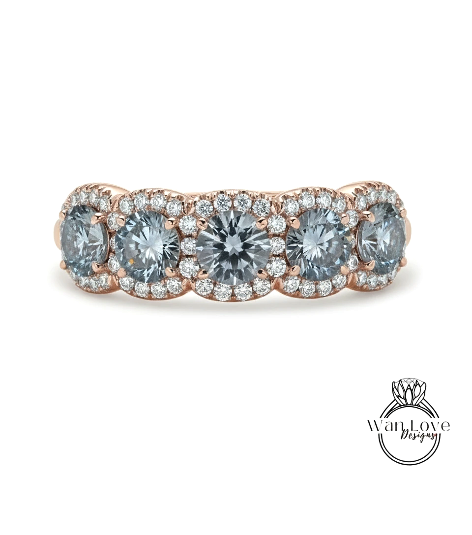 A gold ring with a row of blue diamonds set in the center.