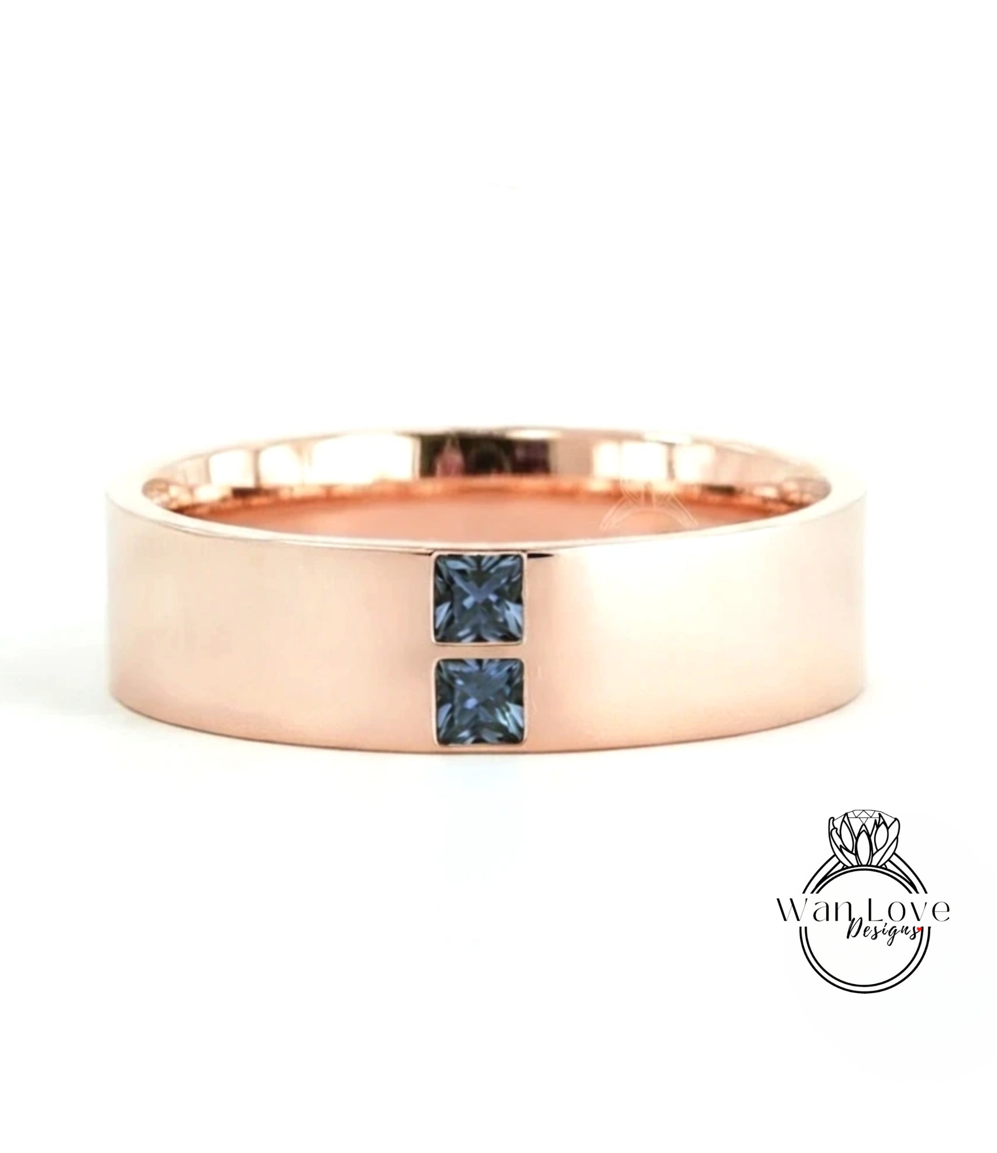 A rose gold ring with a large central gemstone and two smaller stones on either side.