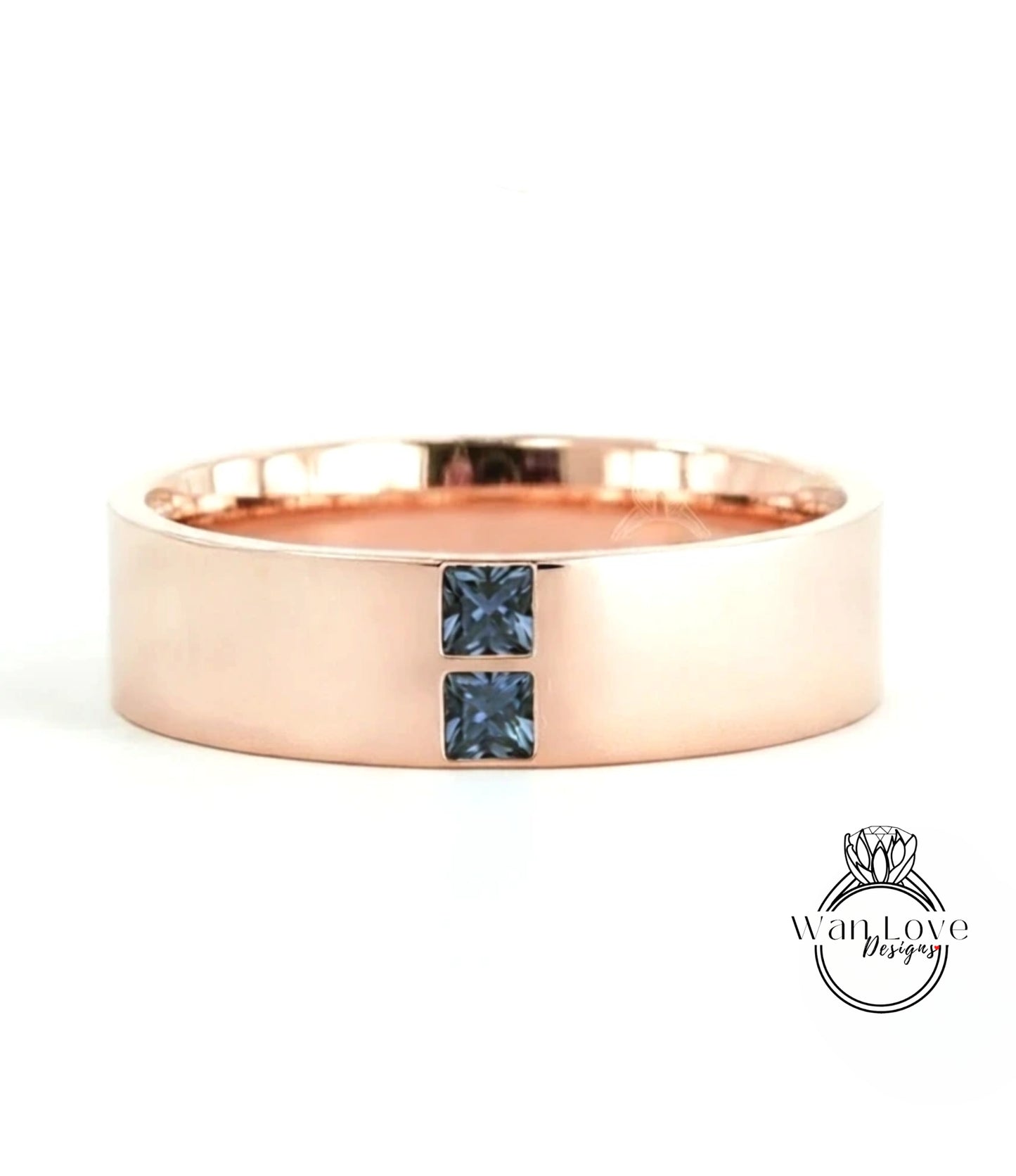 A rose gold ring with a large central gemstone and two smaller stones on either side.