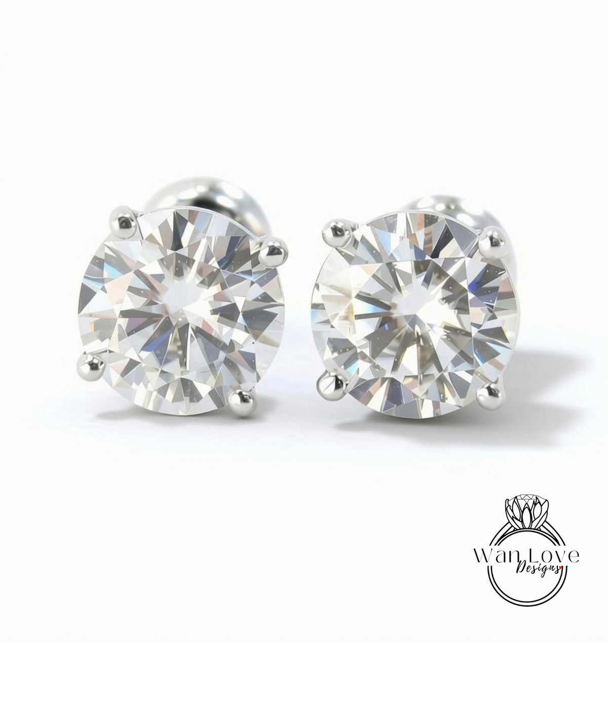 A pair of elegant diamond earrings with a large, brilliant-cut diamond set in a silver metal frame.