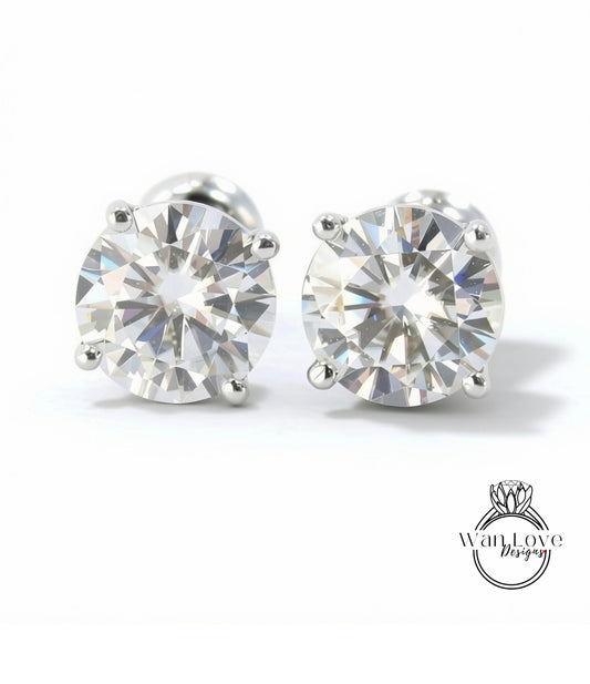 A pair of elegant diamond earrings with a large, brilliant-cut diamond set in a silver metal frame.