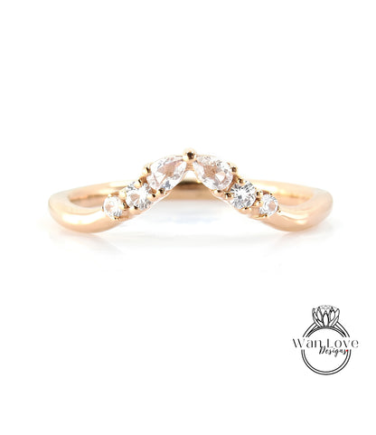 A gold ring with a diamond-encrusted band, featuring a v-shaped design with multiple small diamonds set in the center.