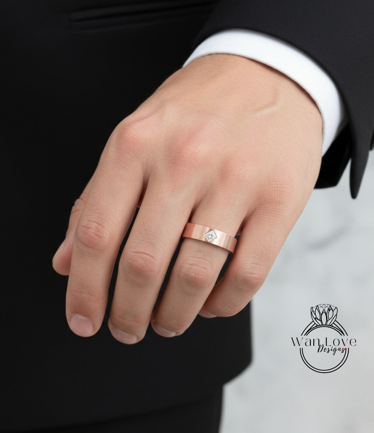 A close-up of a person's hand wearing a gold wedding ring with a diamond.