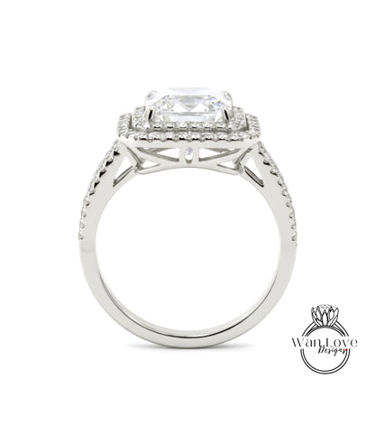 A silver engagement ring with a large central diamond surrounded by smaller diamonds on the band.