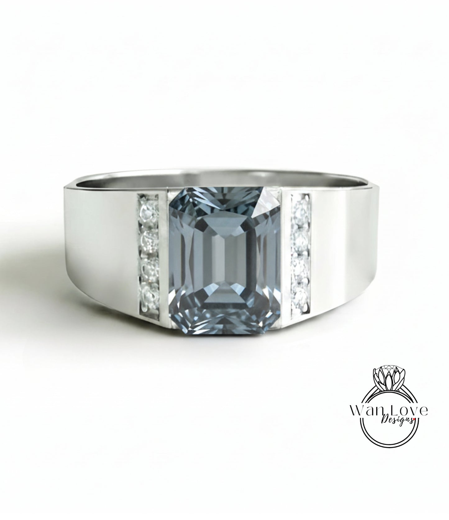 A silver ring with a large blue gemstone, likely a diamond, set in the center.