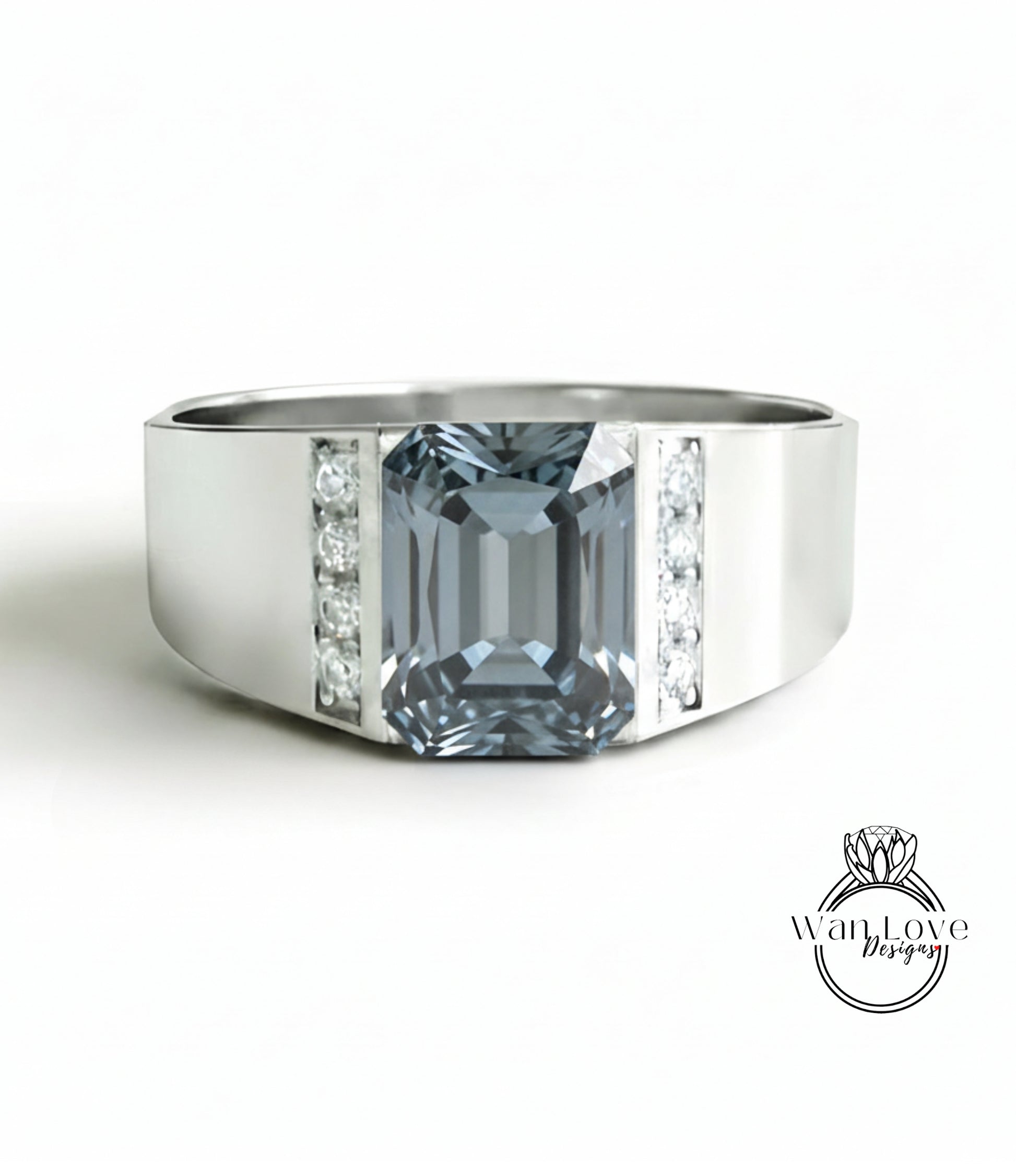 A silver ring with a large blue gemstone, likely a diamond, set in the center.