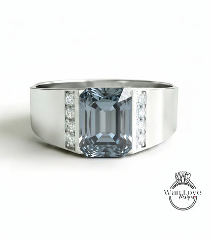 A silver ring with a large blue gemstone, likely a diamond, set in the center.