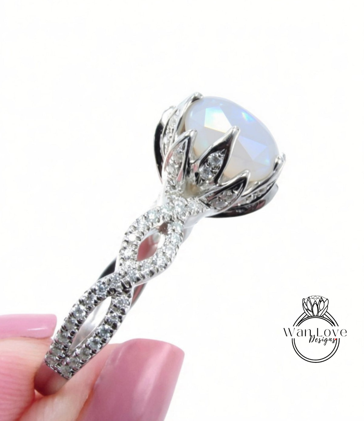 A close-up of a silver ring with a large, round opal gemstone set in a decorative metal band.
